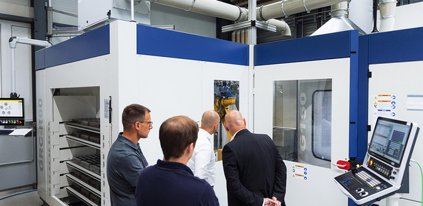 Project team in front of GROB robot cell